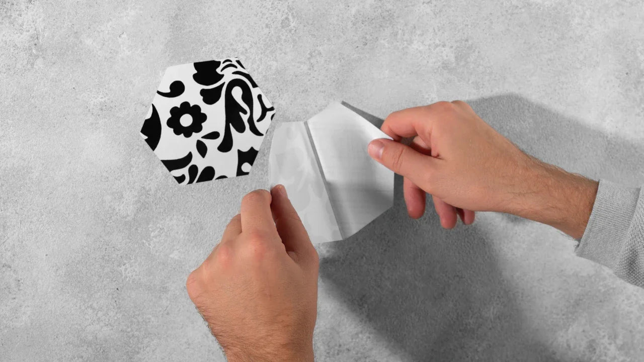 Applying a vinyl sticker smoothly to a clean surface