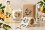 Custom transparent roll labels on glass bottles, a candle jar, cosmetics and kraft packaging