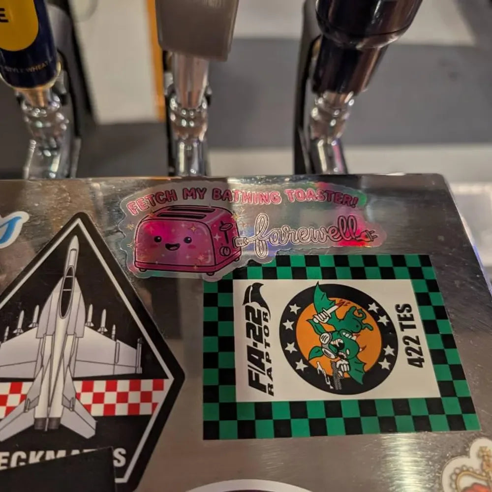 Customer photo of custom stickers displayed on a bar tap surface
