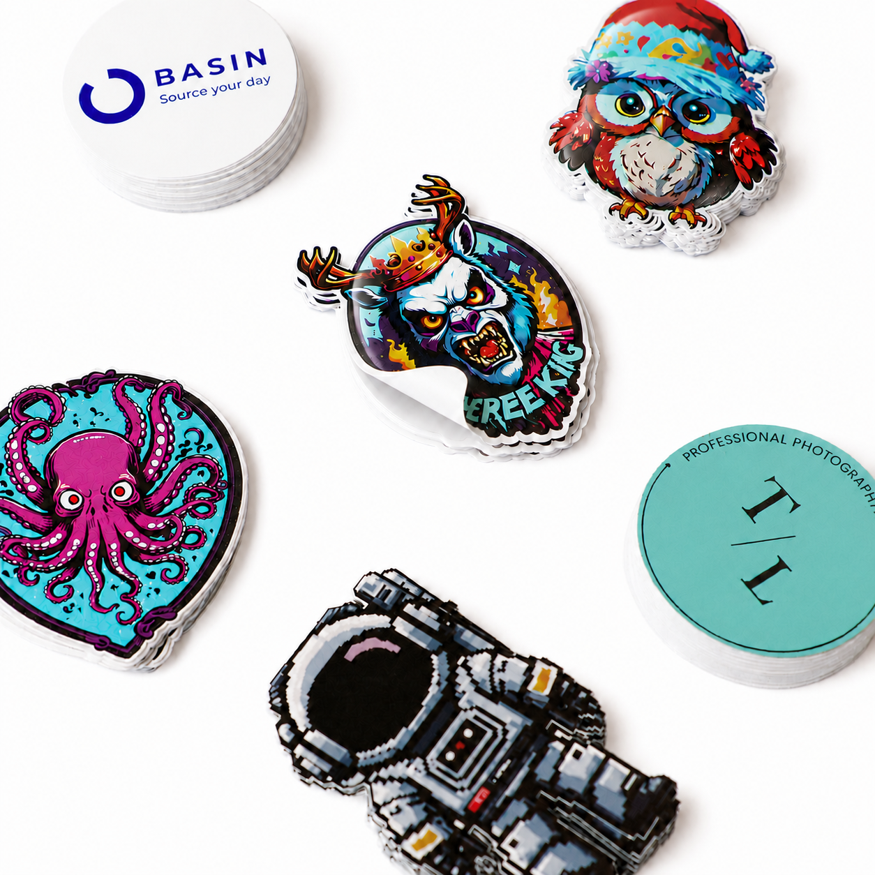 A colorful assortment of custom vinyl stickers in different shapes