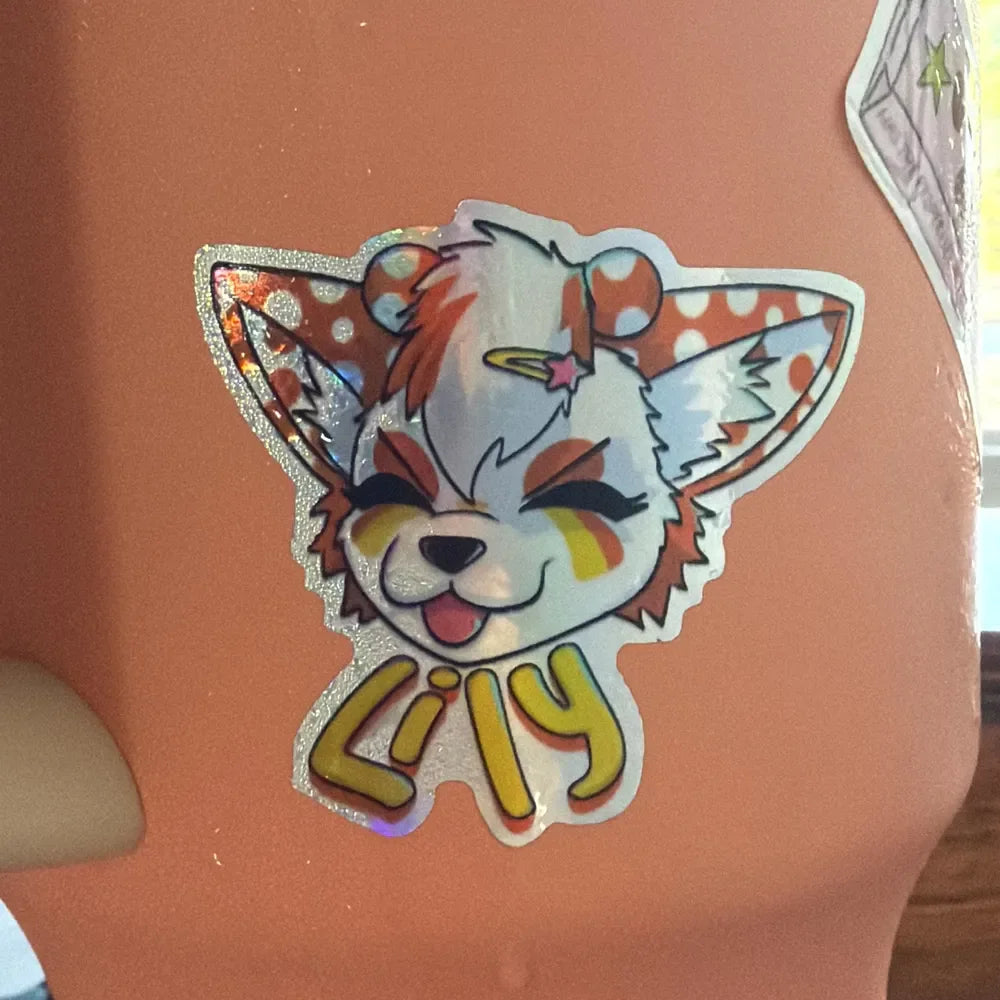 Customer photo of a holographic illustrated sticker on a smooth surface