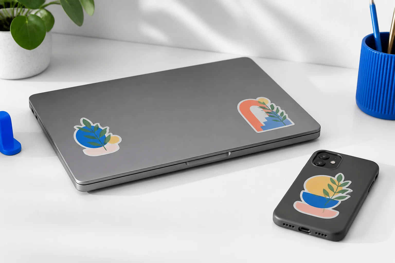Custom stickers applied to a laptop and compatible hard personal devices