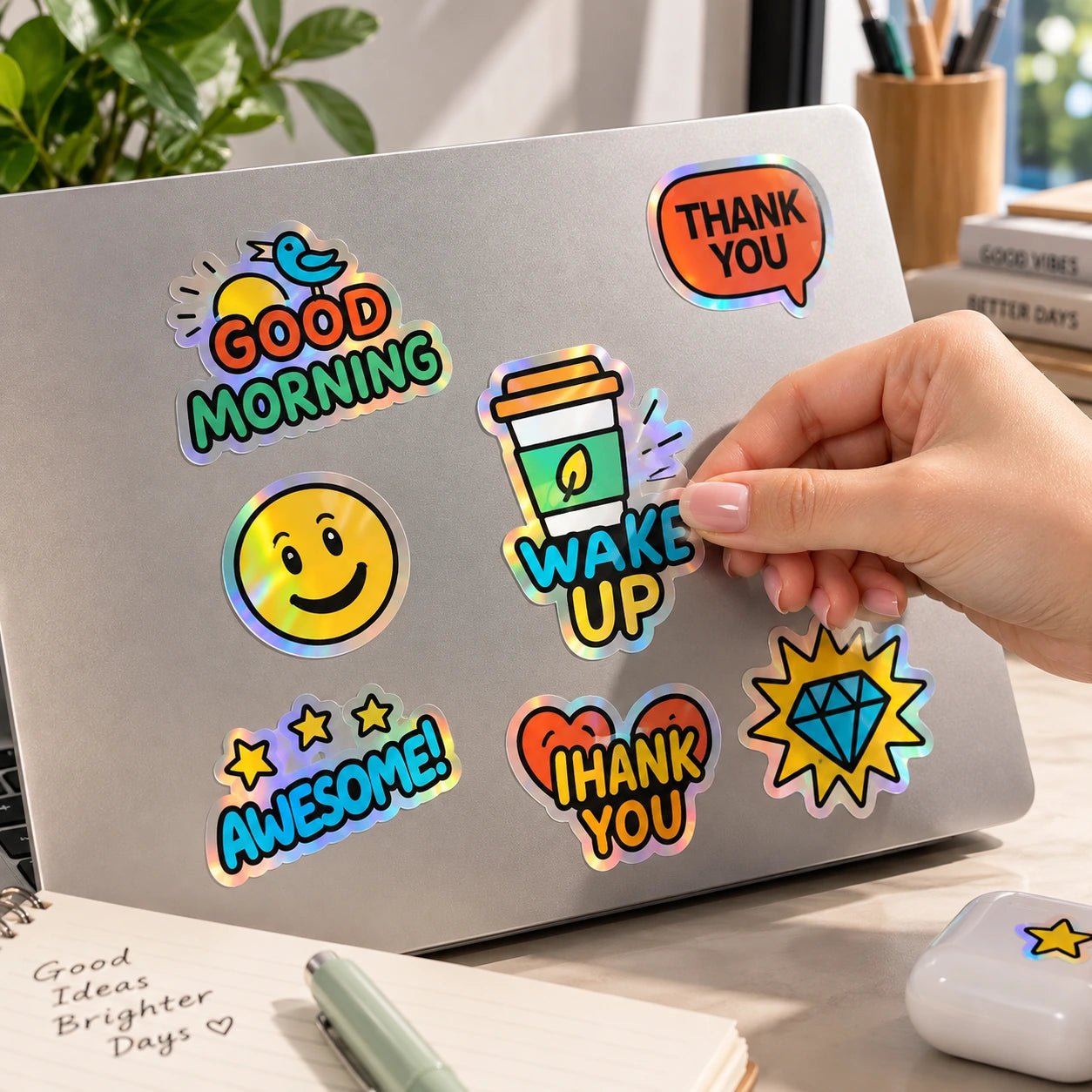 Illustrative holographic sticker designs applied to a laptop